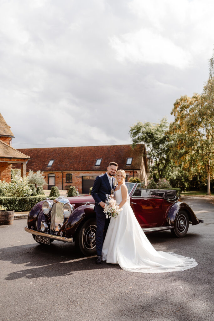 At Home Marquee wedding - Bentley Convertible Wedding Car Bride & Groom - Suzanne Neville Bussotti Dress